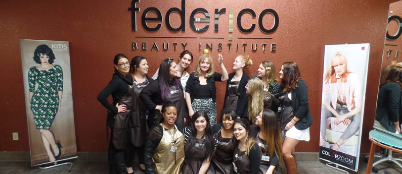 A group of students in Federico Admissions posing in front of Federico's signature wall in the school.