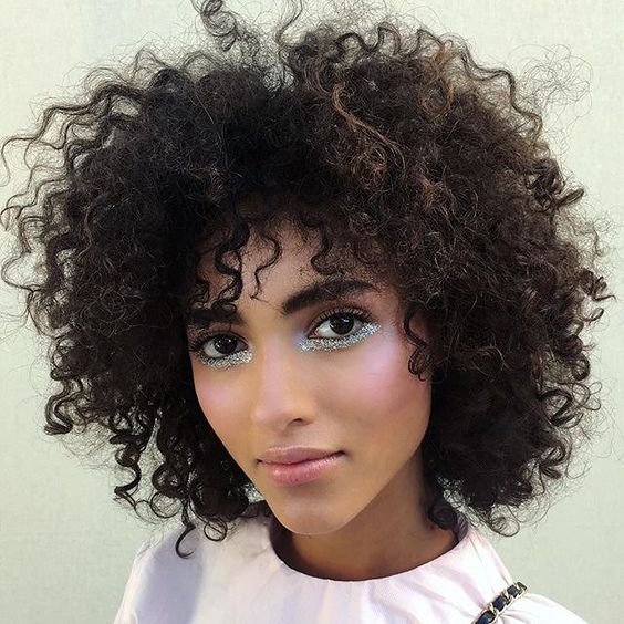 Model with glitter highlighting under her eyes