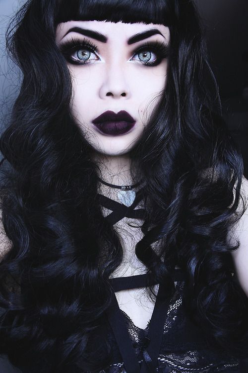 Goth model with accentuated eyes and big, dark lips.