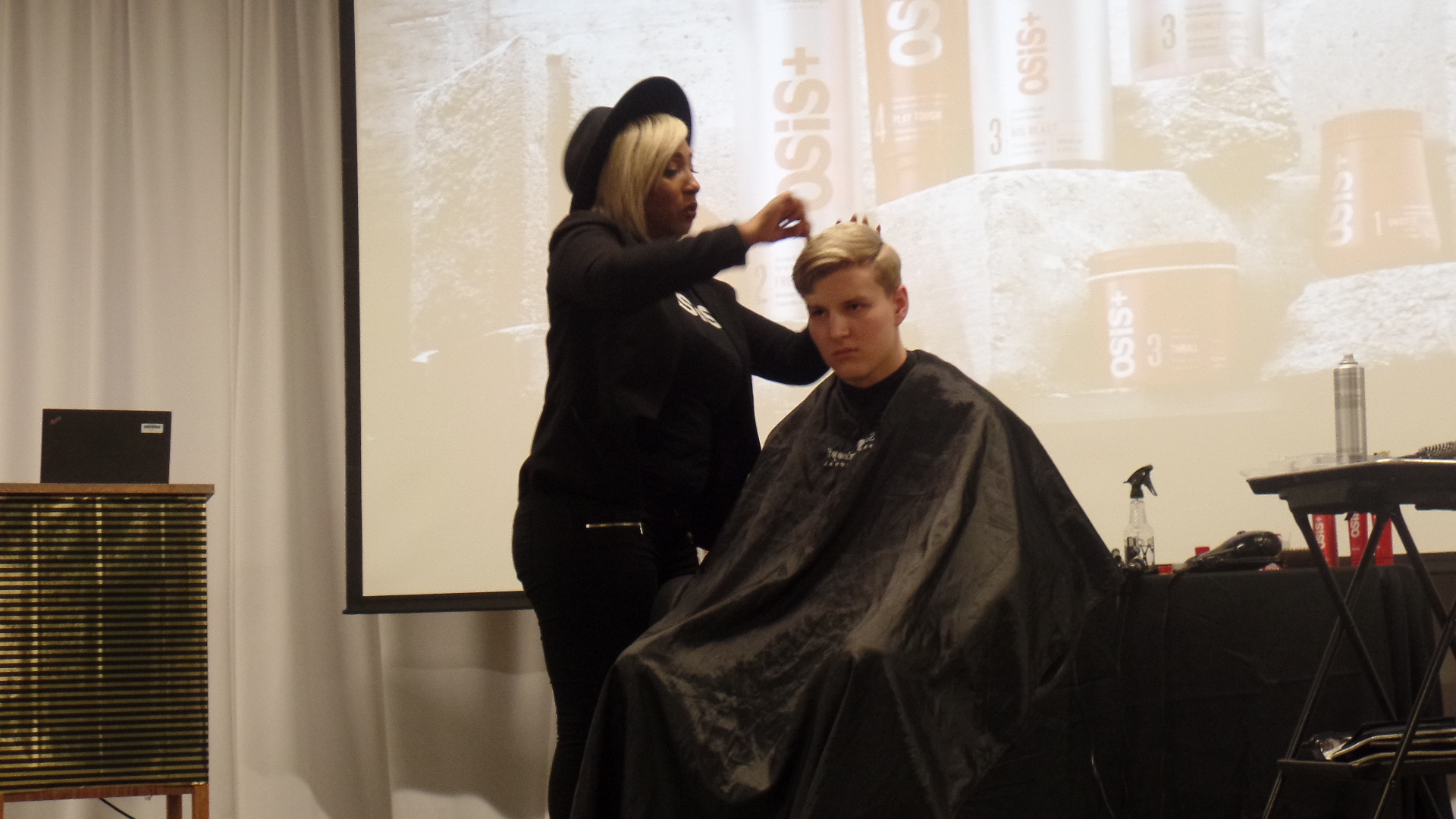 Genia working on student, Trent's, hair.