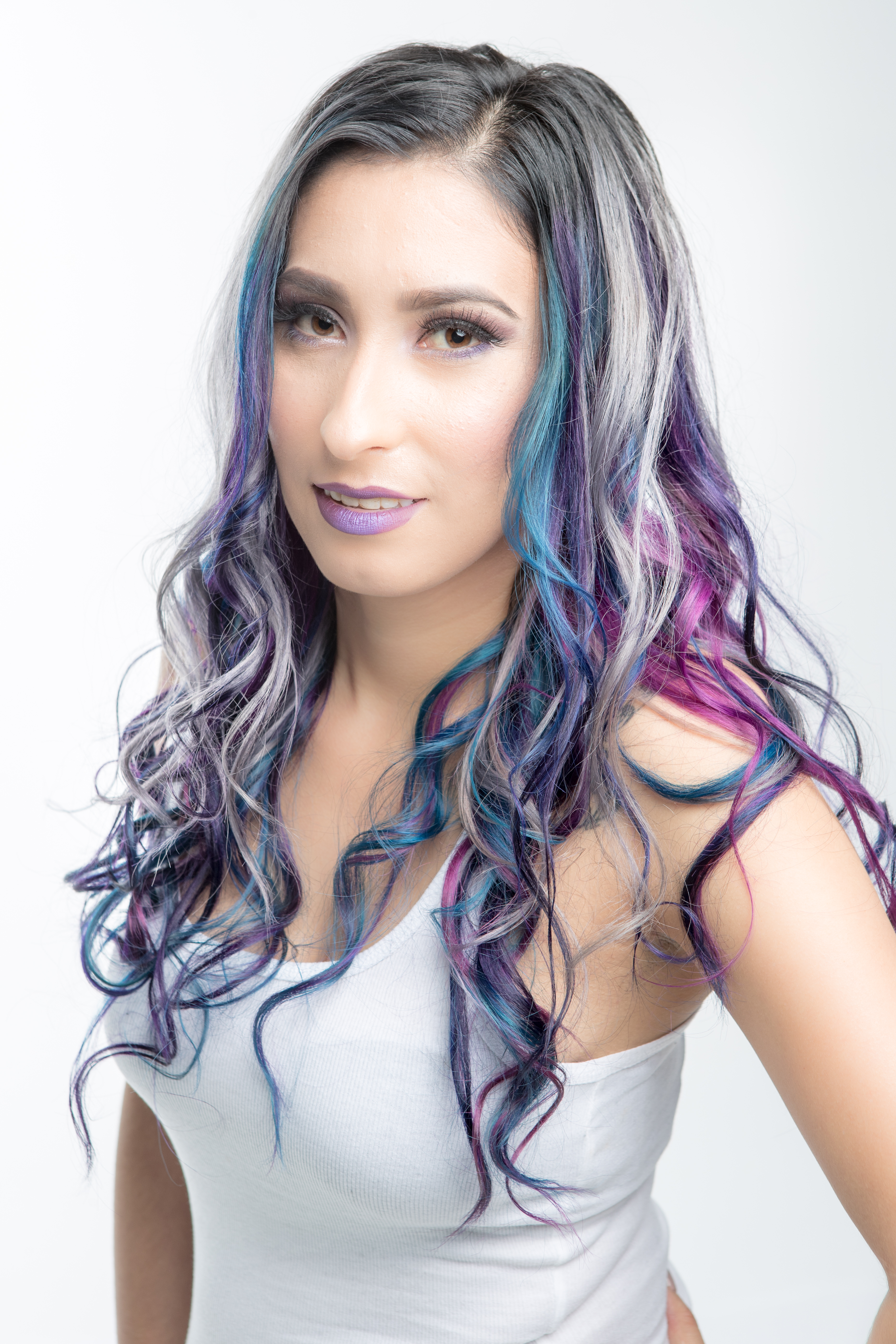 Front view of a long hair style. Hair is mostly silver with blue and purple streaks mixed at the ends.