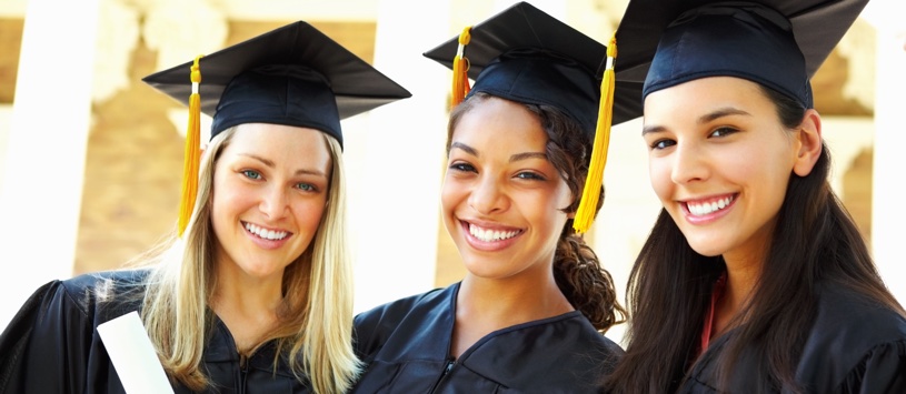 Three young women celebrating their graduation with diplomas