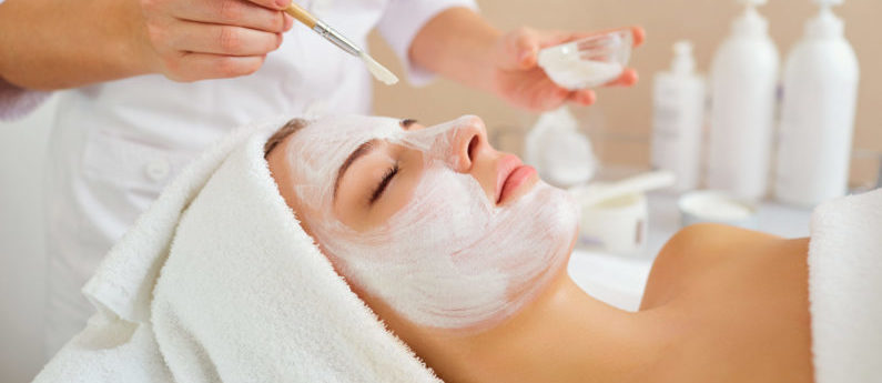 Woman in mask on face in spa beauty salon.